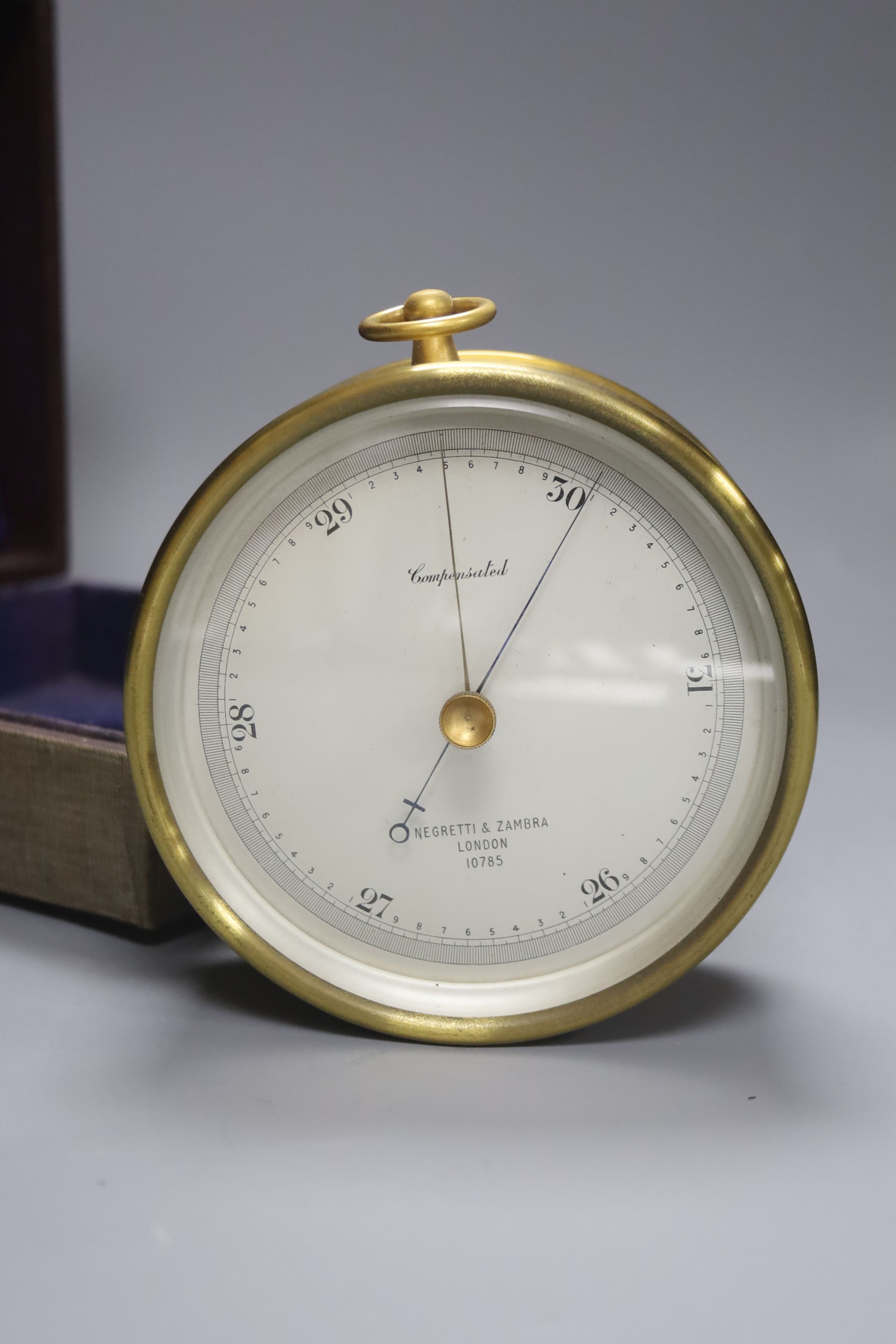 A cased Negretti & Zambra brass cased barometer, diameter 12cm